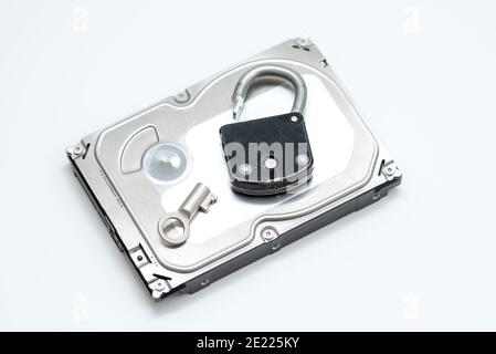 Computer hard disks and open metal padlock symbolizing concept for encrypted data, cyber security on white background Stock Photo