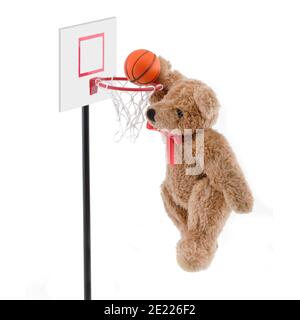 Teddy bear playing basketball dunking the ball Stock Photo