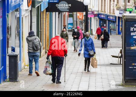 Yeovil, Somerset, UK.  11th January 2020.  Shoppers walking through the town centre at Yeovil in Somerset during the Covid-19 lockdown. Picture Credit: Graham Hunt/Alamy Live News Stock Photo