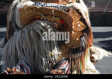 Balinese locals performing Barong, a mythical lion-like creature at a traditional ceremony in Bali. Stock Photo