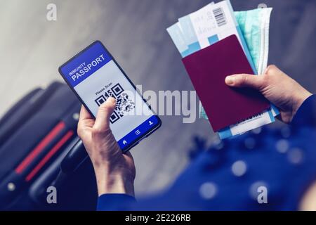 tourist using immunity passport app in mobile phone for travel Stock Photo