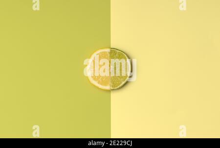 Half Lemon and Lime slice with green and yellow color opposite for spring or summer background. Minimal flatlay concept. Stock Photo