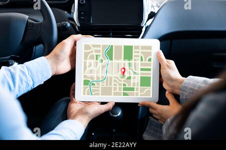 Gps Application. Couple Using Digital Tablet With Opened Navigation Application In Car Stock Photo