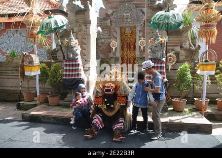 Balinese locals performing Barong, a mythical lion-like creature at a traditional ceremony in Bali. Stock Photo