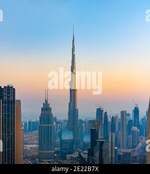 Dubai downtown cityscape hih angle view view at sunset. United Arab Emirates modern architecture and travel abstract