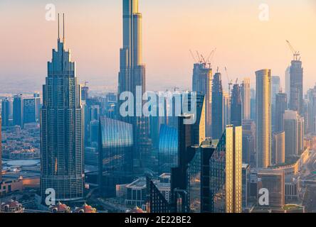 Dubai downtown cityscape hih angle view view at sunset. United Arab Emirates modern architecture and travel abstract