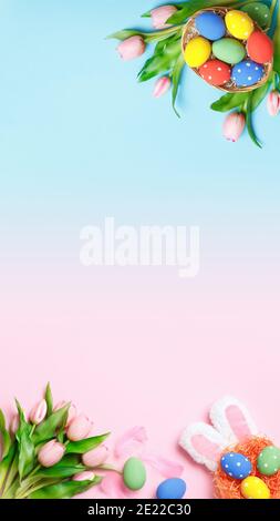 Vertical Easter composition on a pink and blue background. Top view banner with copy space flat lay greeting card. Stock Photo