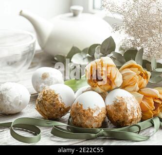 Festive composition for the Easter holiday with decorated eggs and fresh flowers. Stock Photo