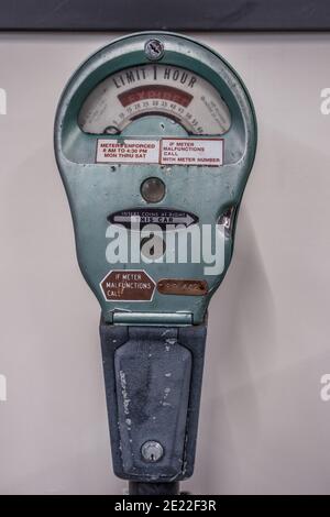 An old vintage worn and used parking meter out of service on display only indoors closeup Stock Photo