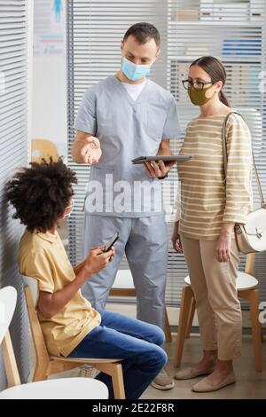 Nurse talking to patient wearing PPE Stock Photo - Alamy