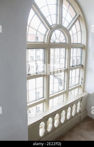 Big white painted wood arched window, Stock Photo
