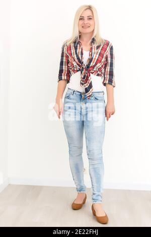 Young woman in coverall on a white background. Female construction worker. Stock Photo