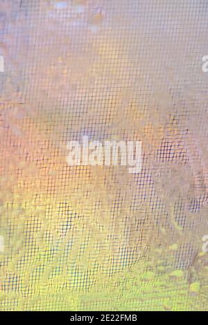 Blurred background of glass with raindrops on the window grid. Stock Photo