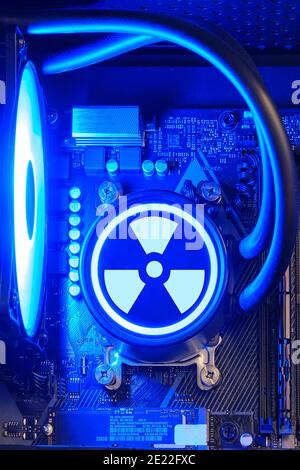 Liquid cooling system inside the computer system unit, gaming PC and the radiation sign Stock Photo