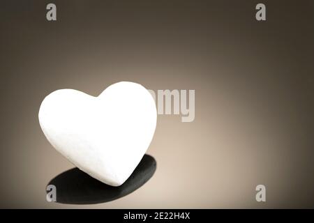 White 3d heart made of polystyrene, on a dark background with place for  text. Artificial love concept, frozen heart. Studio photo. Valentine's Day.  Si Stock Photo - Alamy