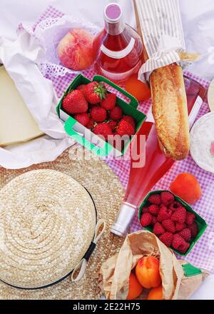 Picnic set in french style: cheese, baguette, berries and rose wine Stock Photo
