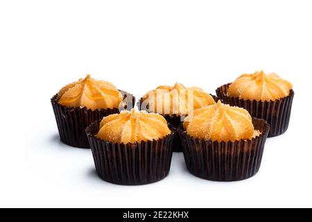 Mini  sponge cakes with orange buttercream topped isolated on white Stock Photo