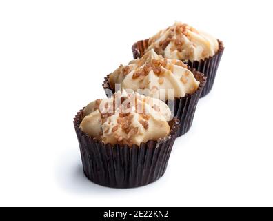 Mini  sponge cakes with caramel buttercream topped isolated on white Stock Photo