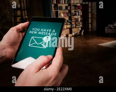You have a new message on the tablet. Online chatting concept. Stock Photo