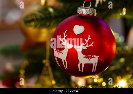 Reindeer christmas tree decoration, a red bauble hanging from a christmas tree Stock Photo