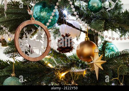 Nordic christmas tree decoration, with gold and teal decorations and white beads all hanging from the tree Stock Photo