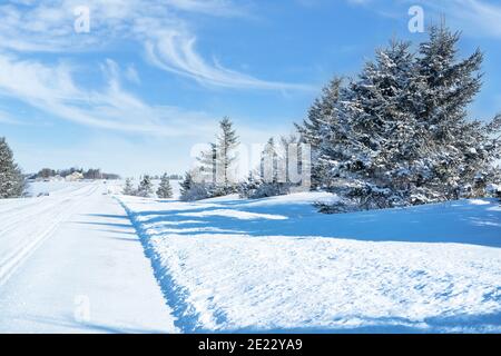 Snow covered back roads leading through rural Prince Edward Island, Canada. Stock Photo