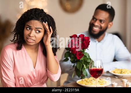 Black Couple On Unsuccessful Blind Date In Restaurant Stock Photo