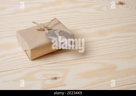 Gift box wrapped in kraft paper tied with twine decorated with tag. DIY. Zero waste Stock Photo