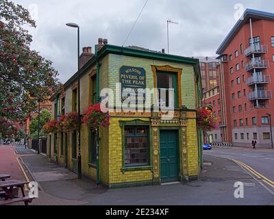 Peveril of the peak , iconic old pub, painted in yellow and green in Manchester Stock Photo