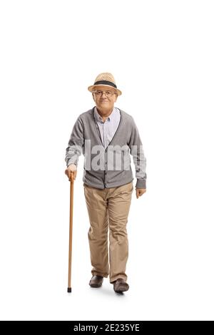 Full length portrait of an elderly gentleman with a cane walking and smiling isolated on white background Stock Photo