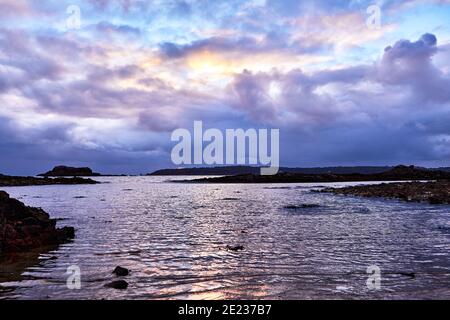 Image of St Aubins Bay at sunset with clouds and calm sea, Jersey CI Stock Photo