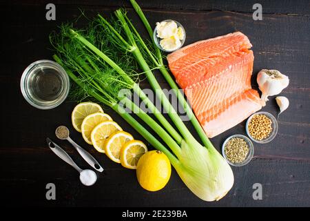 Poached Salmon with Fennel and Lemon Ingredients: Salmon fillet, fennel bulb, and other raw ingredients Stock Photo