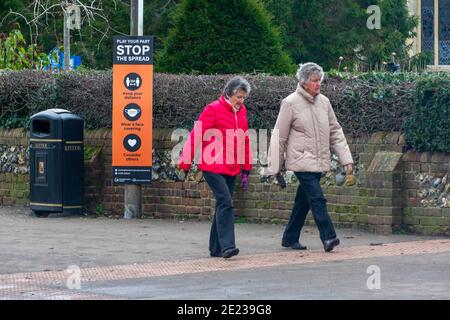 Old Amersham, Buckinghamshire, UK. 11th January, 2021. Two ladies walk past a Play your part, stop the spread public notice. Amersham Old Town was very quiet today as many people heed the Government requirement to stay at home during the latest Covid-19 lockdown. Credit: Maureen McLean/Alamy Stock Photo