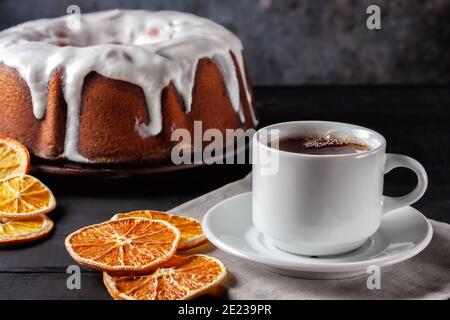 Cup of tea with oranges and a piece of homemade muffin Stock Photo