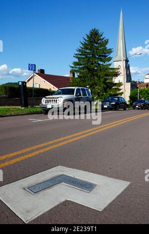 Plaque in Washington Street marking position of Fort Cumberland bastion, First Presbyterian church in background, Cumberland, Maryland MD, USA Stock Photo