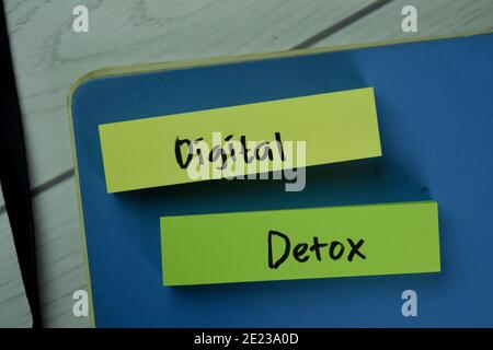 Digital Detox write on sticky notes isolated on Wooden Table. Stock Photo