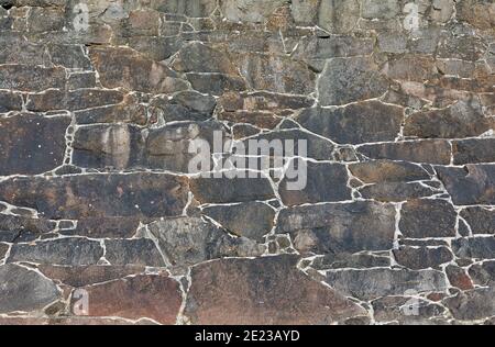 Image of a granite stone coastal wall. Textured background. Stock Photo