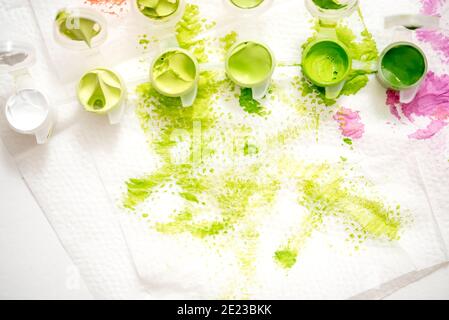 Abstract watercolor hand painted background. Green stain of paint on a white napkin. Stock Photo