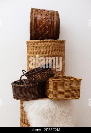 Stack of six different wicker baskets, handmade craft home storage elements for natural interior design at white background Stock Photo