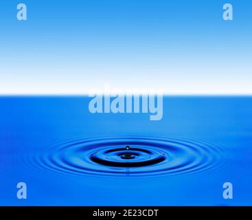 Circular waves on the surface of the blue water Stock Photo