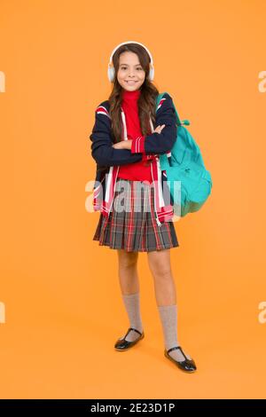 English audio course. study english language online. british school in england. vacation in great britain. ebook and private lesson. small girl headset with backpack. kid with english flag on jacket. Stock Photo