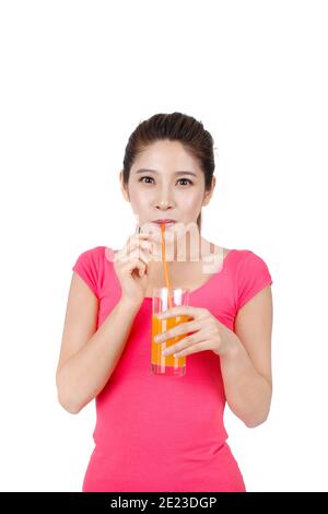 Young woman in pink dress drinking a glass of orange juice high quality photo Stock Photo
