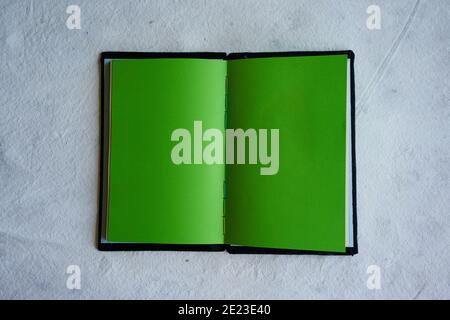 Top view of an open notebook with blank green sheets isolated on a white background Stock Photo