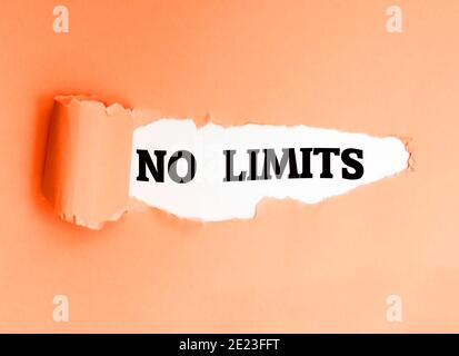 No Limits, written in English on a torn paper, encouraging you to take action and be proactive. Stock Photo