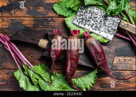 Purple beet on a cutting board. Dark wooden background. Top view Stock Photo