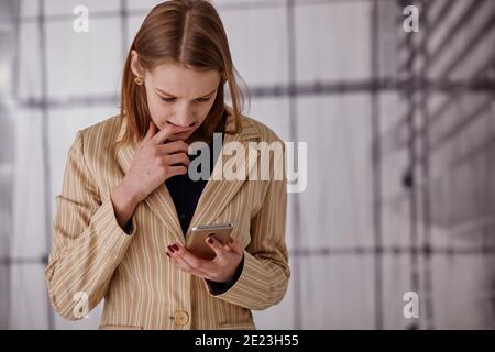 Businesswoman sending message with smartphone Stock Photo