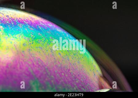 Colorful surface of a soap bubble on a black background Stock Photo