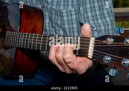 Senior man playing classical guitar outdoors Stock Photo