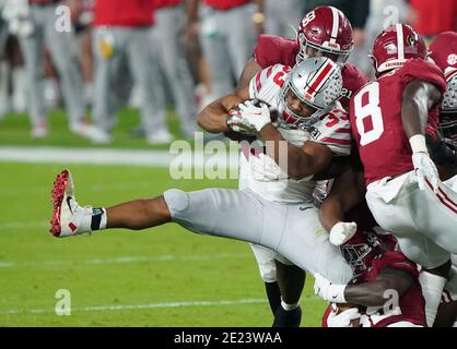 Miami, United States. 11th Jan, 2021. Ohio State Buckeyes running back Master Teague III (33) is stopped by Alabama Crimson Tide defensive lineman Christian Barmore (58) during the 2021 NCAA National Championship football game, in Miami on Monday, January 11, 2021. Photo by Hans Deryk/UPI Credit: UPI/Alamy Live News Stock Photo