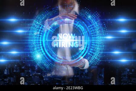 Business, Technology, Internet and network concept. Young businessman working on a virtual screen of the future and sees the inscription: Now hiring Stock Photo